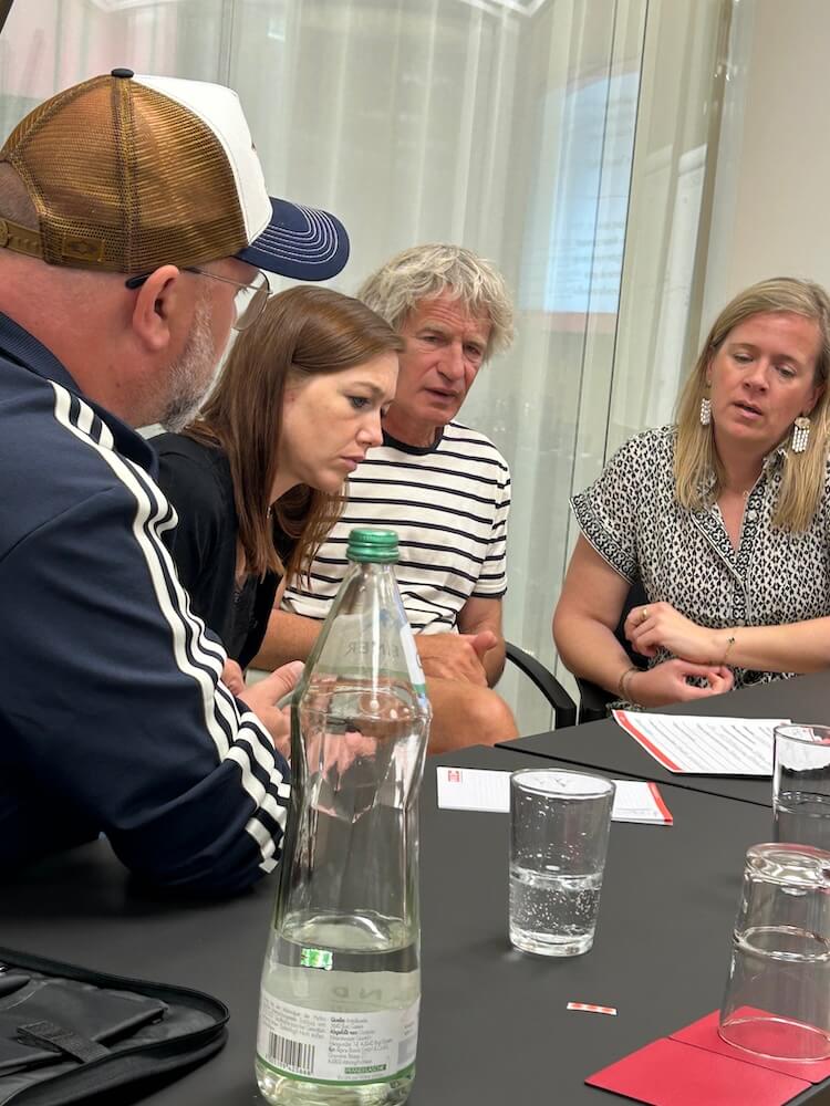 People engage in intensive discussions at a workshop in Linz